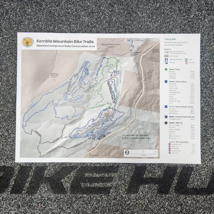 A printed map of the Kembla Mountain Bike Trails on the Bike Hub floor mat