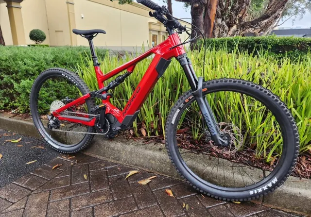 A red Norco full-suspension mountain bike