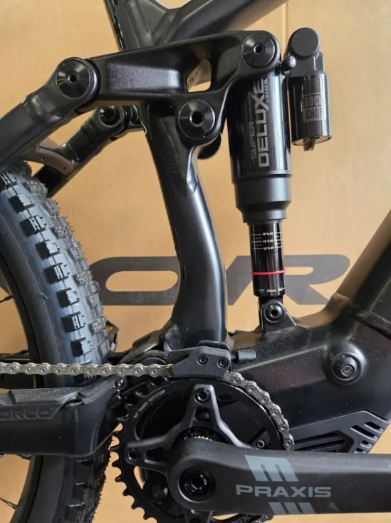 Close-up of a RockShox rear shock and Praxis crank on a Norco e-MTB