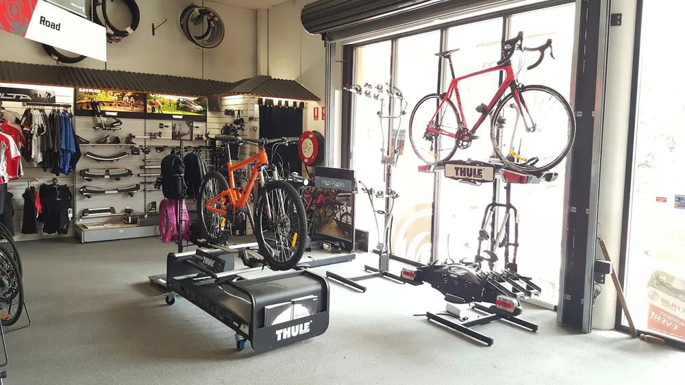The bright accessories area with a road bike in a work stand
